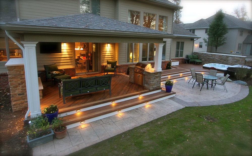 Custom deck and patio pavilion with outdoor living space and seasonal landscaping