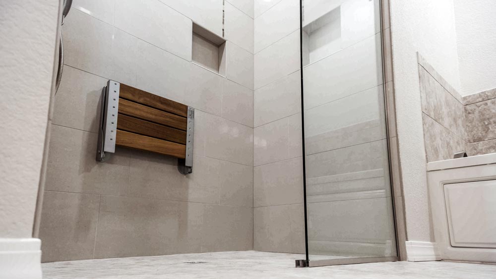 Walk-in shower conversion with bench seat and handheld showerhead for accessibility