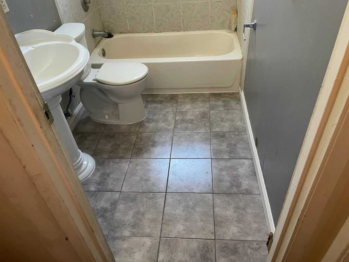 Small mosaic tile installation on bathroom floor with waterproof membrane