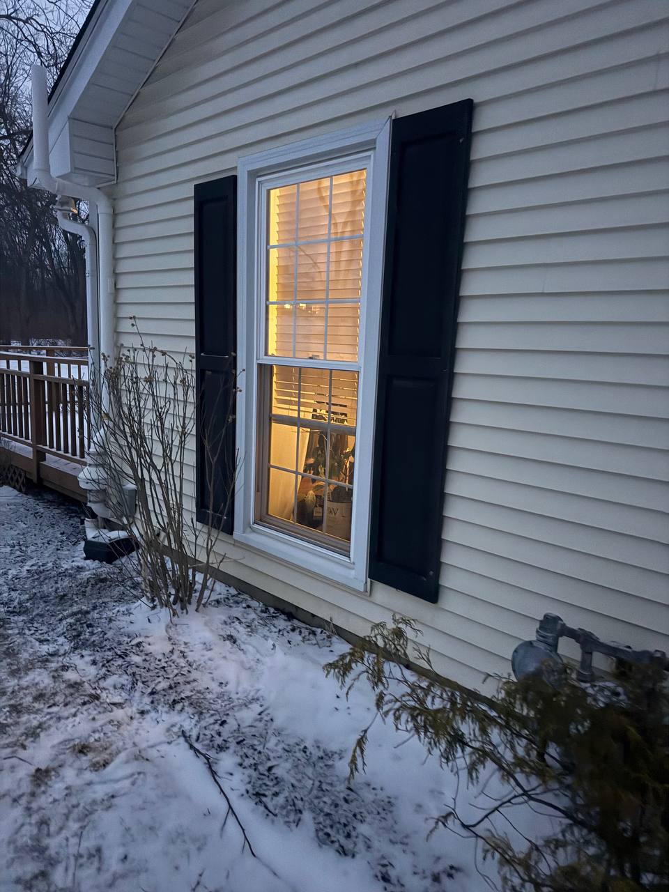 Exterior window with decorative shutters and fresh trim paint