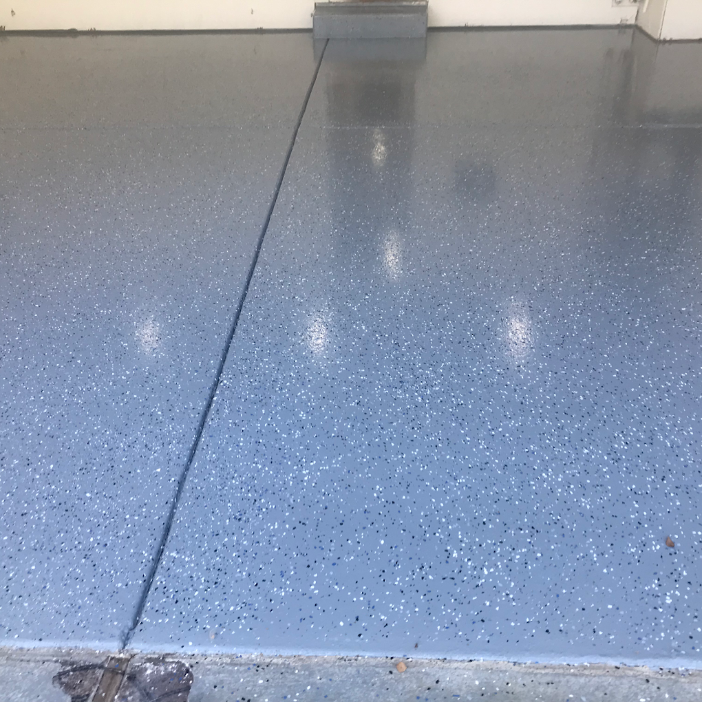 Garage floor with finished epoxy coating in grey metallic flake