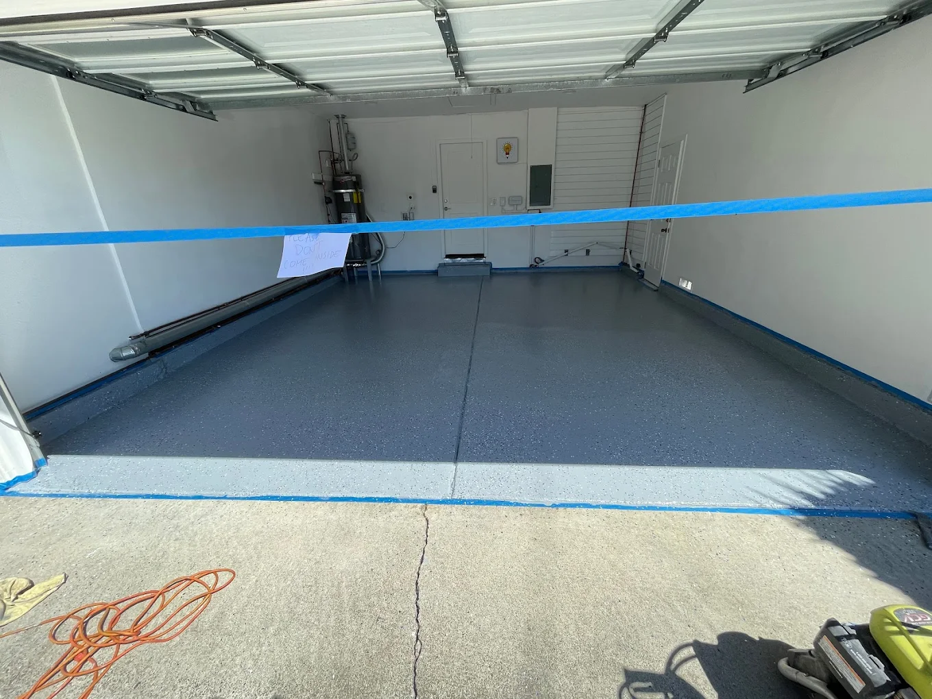 Garage epoxy floor coating application showing professional coverage