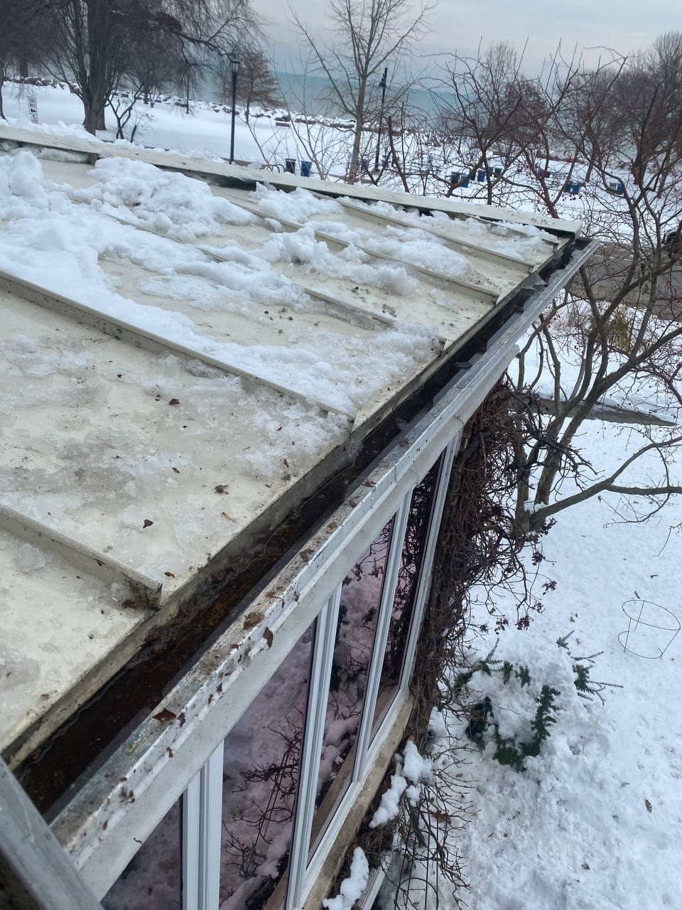Winter gutter maintenance preventing ice dam formation on residential roof