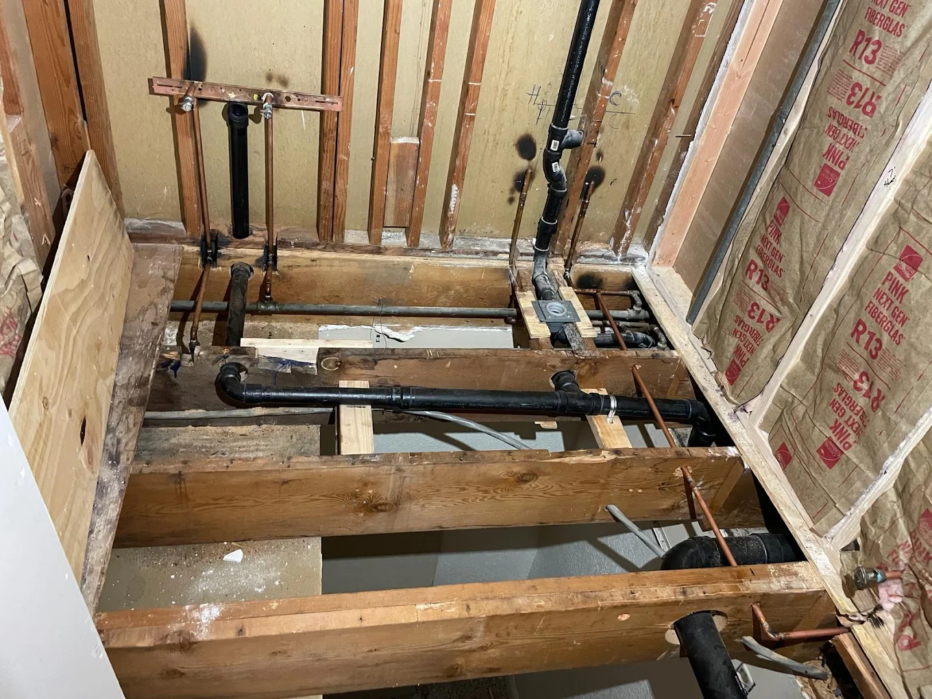 Plumbing rough-in for new bathroom with copper and PEX supply lines