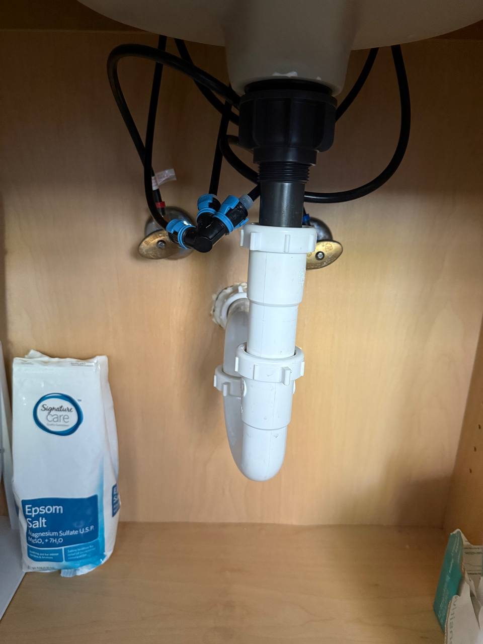 Under-sink plumbing repair with new supply lines and P-trap