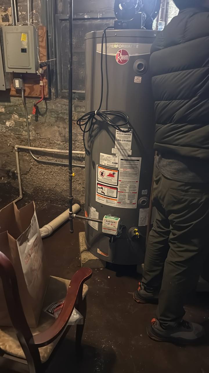 Rheem tankless water heater installation mounted on utility room wall
